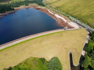 Brecon Beacons, Wales - August 2022: Aerial view of the dam and very low water level in the Beacons Reservoir in the Taff Fawr Valley of the Brecon Beacon mountains.