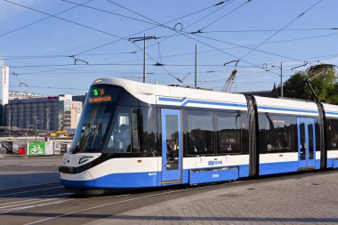 Amsterdam, Netherlands - August 2022: Electric tram passing through one of the streets in the city centre