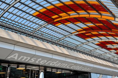 Amsterdam, Netherlands - August 2022: Entrance to the railway and bus station under a  curved roof at Amsterdam Centraale.