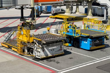 Amsterdam, Netherlands - August 2022: Air frieght pallet loaders parked on the airport apron at Schipol airport