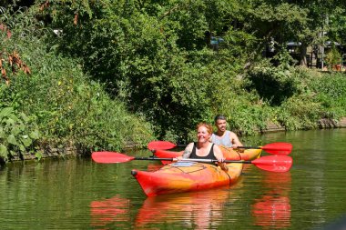 Utrecht, Netherlands - August 2022: Two people kayaking on one of the city's canals