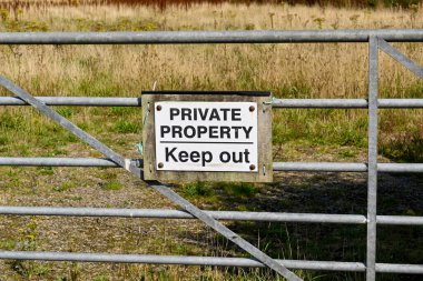 Private Property sign on a farm gate. No people.