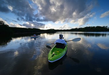 Active senior and woman kayaking in Everglades National Park, Florida.