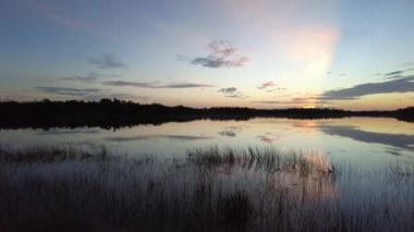 Colorful dawn cloudscape over Nine Mile Pond in Everglades National Park, Florida on calm summer morning 4K.