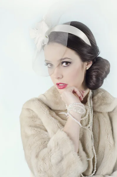 Beautiful girl in fur coat with veil on white background — Stock Photo, Image