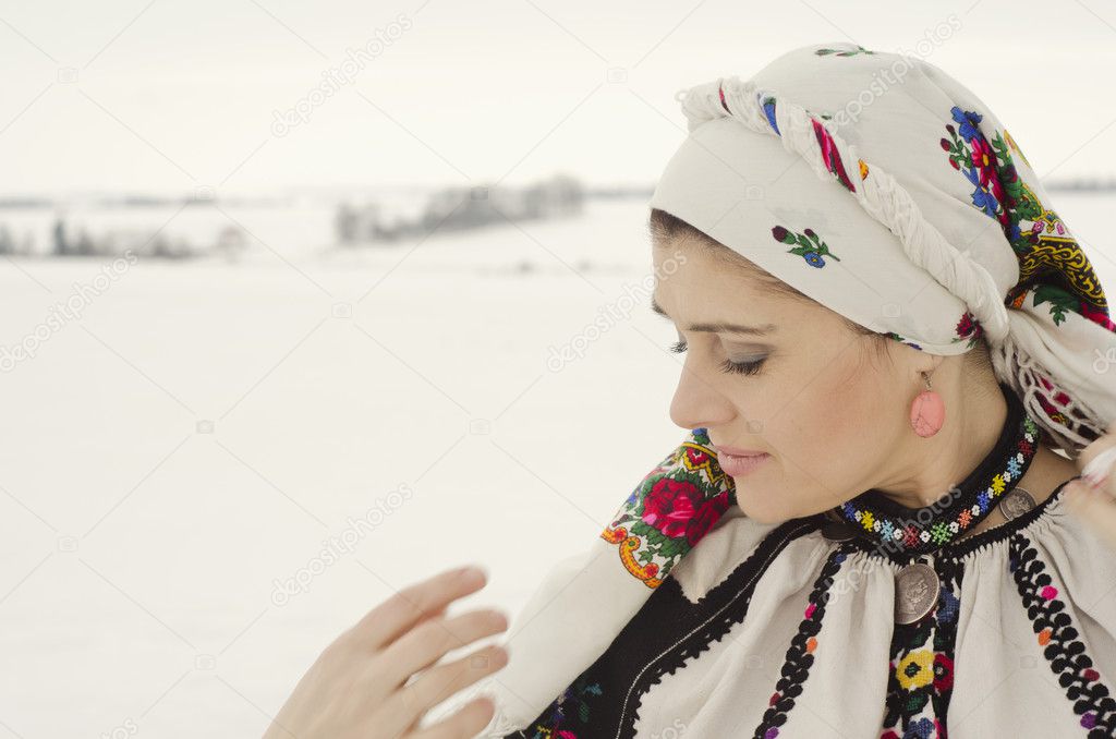 Woman in traditional ukrainian cloth on snow