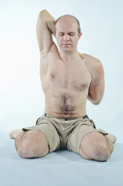 Portrait of strong man sitting in yoga pose — Stock Photo, Image