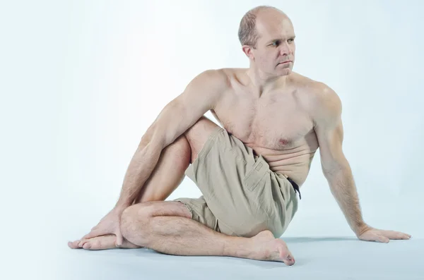 Portrait of strong man sitting in yoga pose — Stock Photo, Image