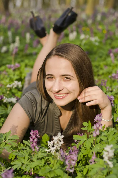 Portrait of beautiful smiling girl in corydalis — Stock Photo, Image