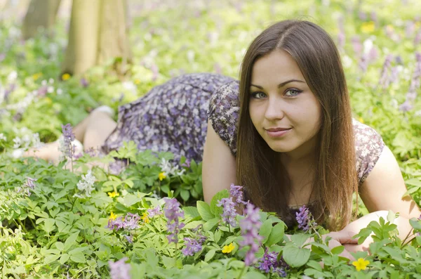 Portrait of beautiful girl among corydalis — Stock Photo, Image