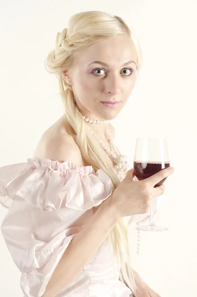 Studio portrait of beautiful woman dressed in old fashionable style with glass of wine — Stock Photo, Image