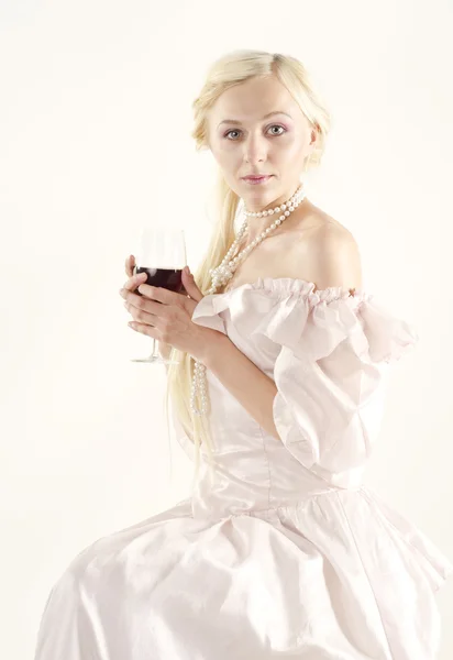 Studio portrait of beautiful woman dressed in old fashionable style with glass of wine — Stock Photo, Image