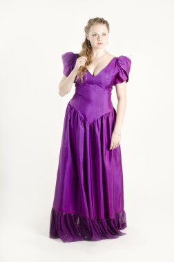 Stüdyo portre, çekici güzel ve gülümseyen bir kız beyaz zemin üzerine eski moda kadınlar gibi giyinmiş.