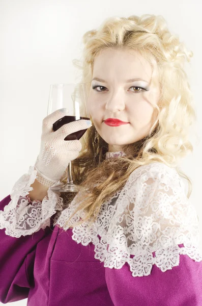 Studio portrait of a beautiful, attractive girl with a red glass — Stock Photo, Image