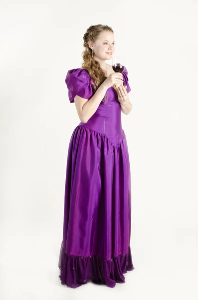 Studio portrait of a beautiful, attractive girl with a glass of red wine and dressed like an old fashionable lady on white background — Stock Photo, Image