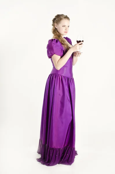 Studio portrait of a beautiful, attractive girl with a glass of red wine and dressed like an old fashionable lady on white background — Stock Photo, Image