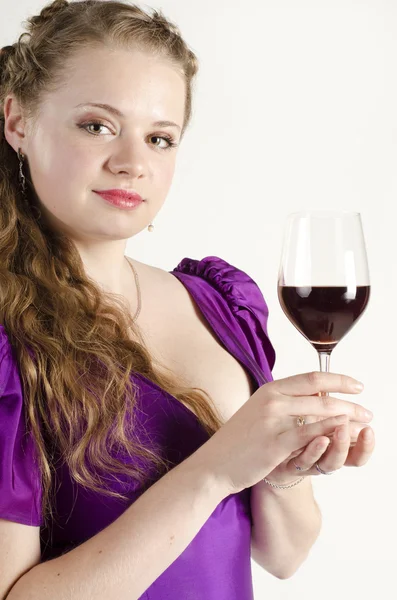 Studio portrait of a beautiful, attractive girl with a glass of red wine and dressed like an old fashionable lady on white background — Stock Photo, Image