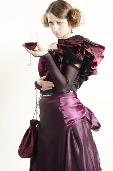 Studio portrait of beautiful woman dressed in old fashinable style with a glass of wine — Stock Photo, Image