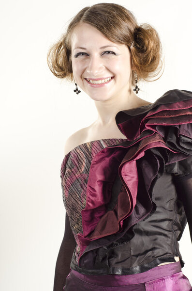 Studio portrait of an attractive, beautiful, smiling woman dressed in old fashionable style