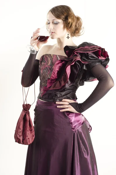 Studio portrait of beautiful woman dressed in old fashinable style with a glass of wine — Stock Photo, Image