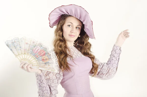 Studio portrait of an attractive and beautiful woman with a fan dressed in old fashinable style — Stock Photo, Image