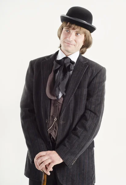 Studio portrait of a smiling business man with a cane in hands dressed in retro style — Stock Photo, Image