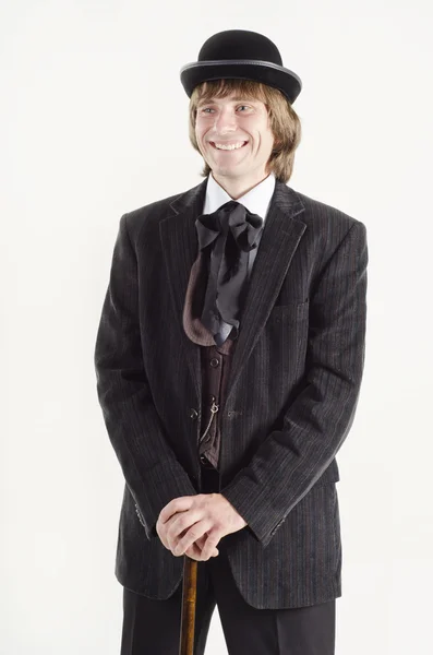 Studio portrait of a smiling business man with a cane in hands dressed in retro style — Stock Photo, Image