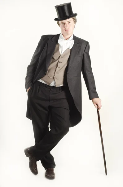 Studio portrait of an old fashionable young man with a cane in a hand — Stock Photo, Image