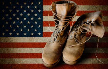 Army boots on sandy flag background clipart