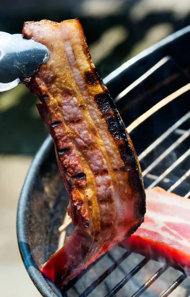 Thick bacon on grill — Stock Photo, Image