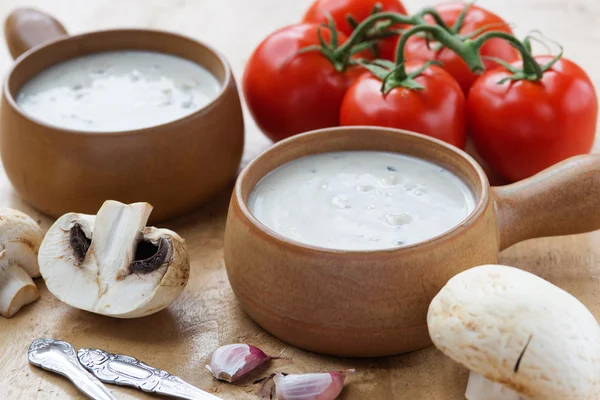 Creamy mushroom soup in two clay pots — Stock Photo, Image