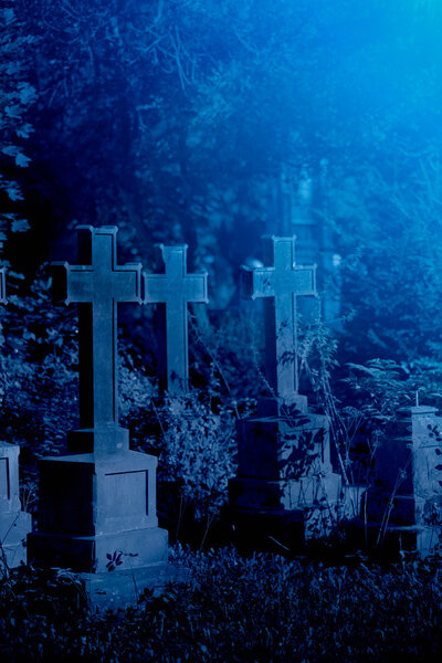 Old misty graveyard at night