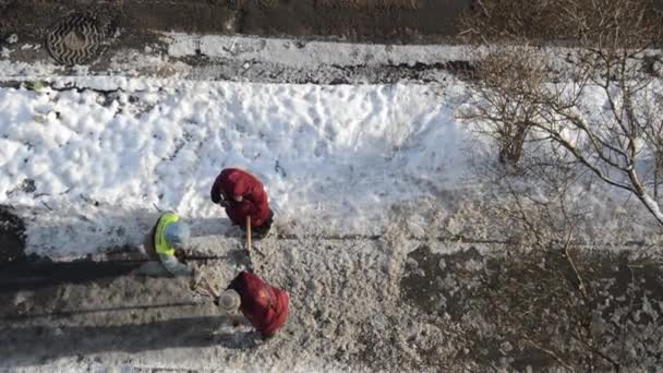 Woman Workers Break Ice Crowbar Road — Stockvideo