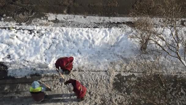 Woman Workers Break Ice Crowbar Road — Stock Video