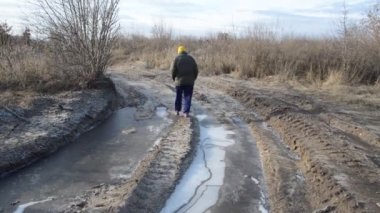 A woman walks away on a snowy road