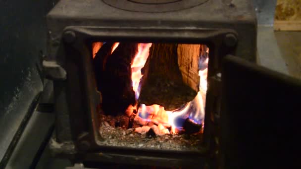 部屋を暖めるために鋳鉄ストーブの火室で燃焼しています — ストック動画