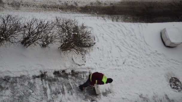 Man Janitor Removes Snow Shovel Street — Stock Video