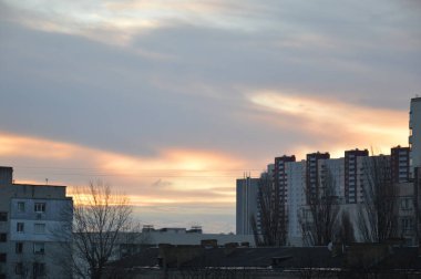 Şehirdeki pembe bulutların arka planına karşı yeni binalar