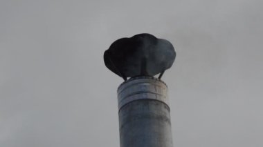 Ocağın metal bacasından duman çıkıyor.