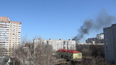 Savaş sırasında şehirde bir roket ya da bomba patlamasından siyah duman çıkar.