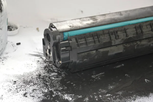 Charging the laser printer cartridge with toner the powder