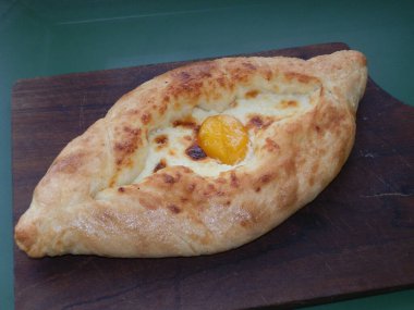 Georgian khachapuri bun with cheese and the egg