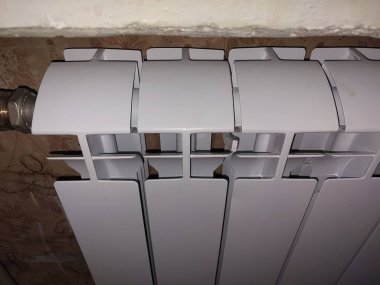Installed metal heating radiators in the living room in a the apartment