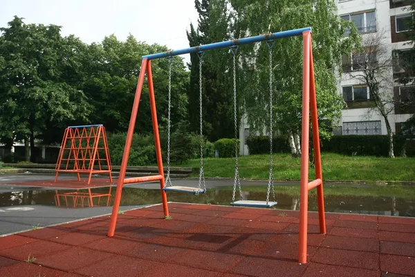 Playground children's child chain swings on summer kids playground — Stock Photo, Image