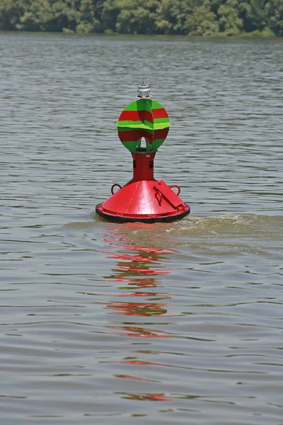 Red buoy floating in the river — Stock Photo, Image