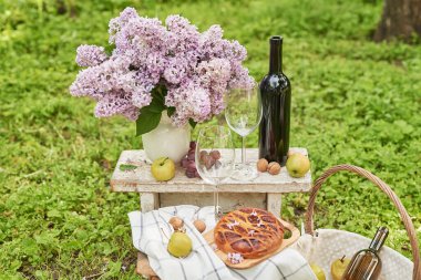 Bahçede yaz pikniği. Şarap, turta, meyve ve çiçekler. Durgun hayat. Paskalya yemeği ve masa..