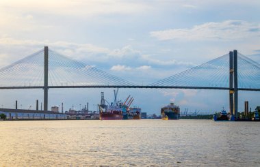 Savannah, Georgia, USA - July 24 2022: View of the harbor port and Talmadge Memorial Bridge of Savannah at the summer sunset
