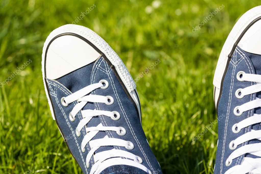 Retro Sneakers On Green Grass Background