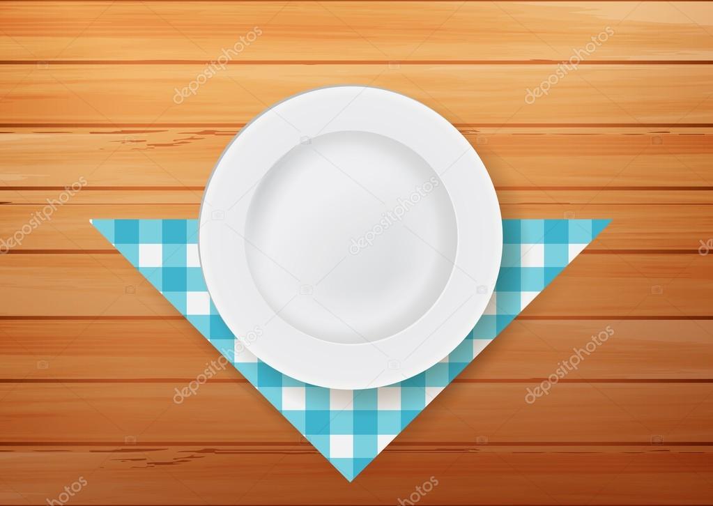 Plate with napkin on wood background