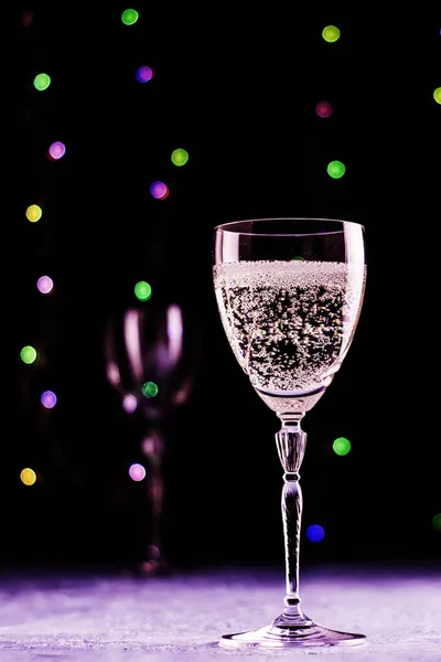 Een Glas Champagne Een Zwarte Achtergrond Met Lichtjes Nog Een — Stockfoto